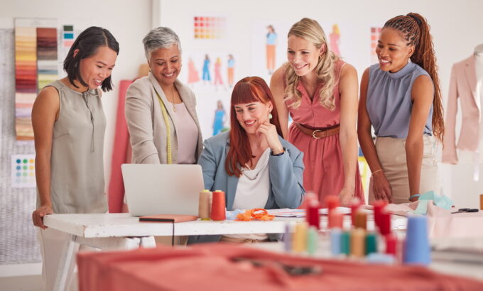 Business people, laptop and fashion meeting for marketing, clothing or ecommerce at the office. Gro.